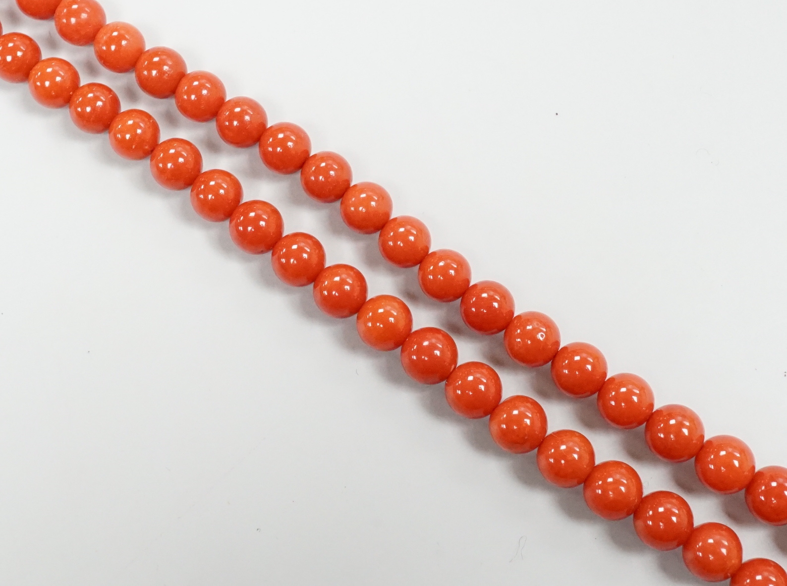 A single strand coral bead necklace, with 750 yellow metal clasp, 48cm.